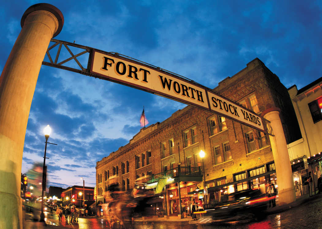Image of a road leading to the Fort Worth Stockyards entrance, featuring Cowtown Segway Adventures and highlighting the historic Fort Worth Stockyards experience.